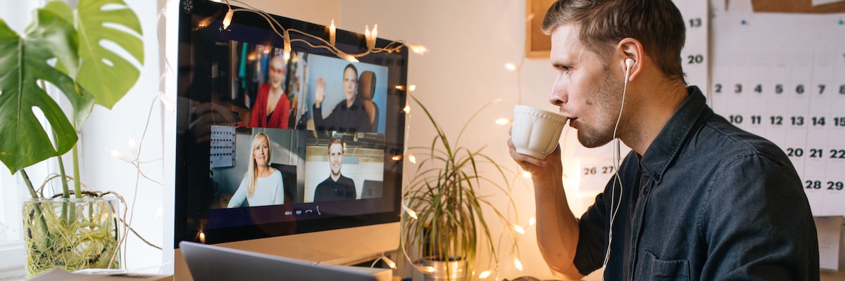 Essential oils for focus: man drinking coffee while on a video call